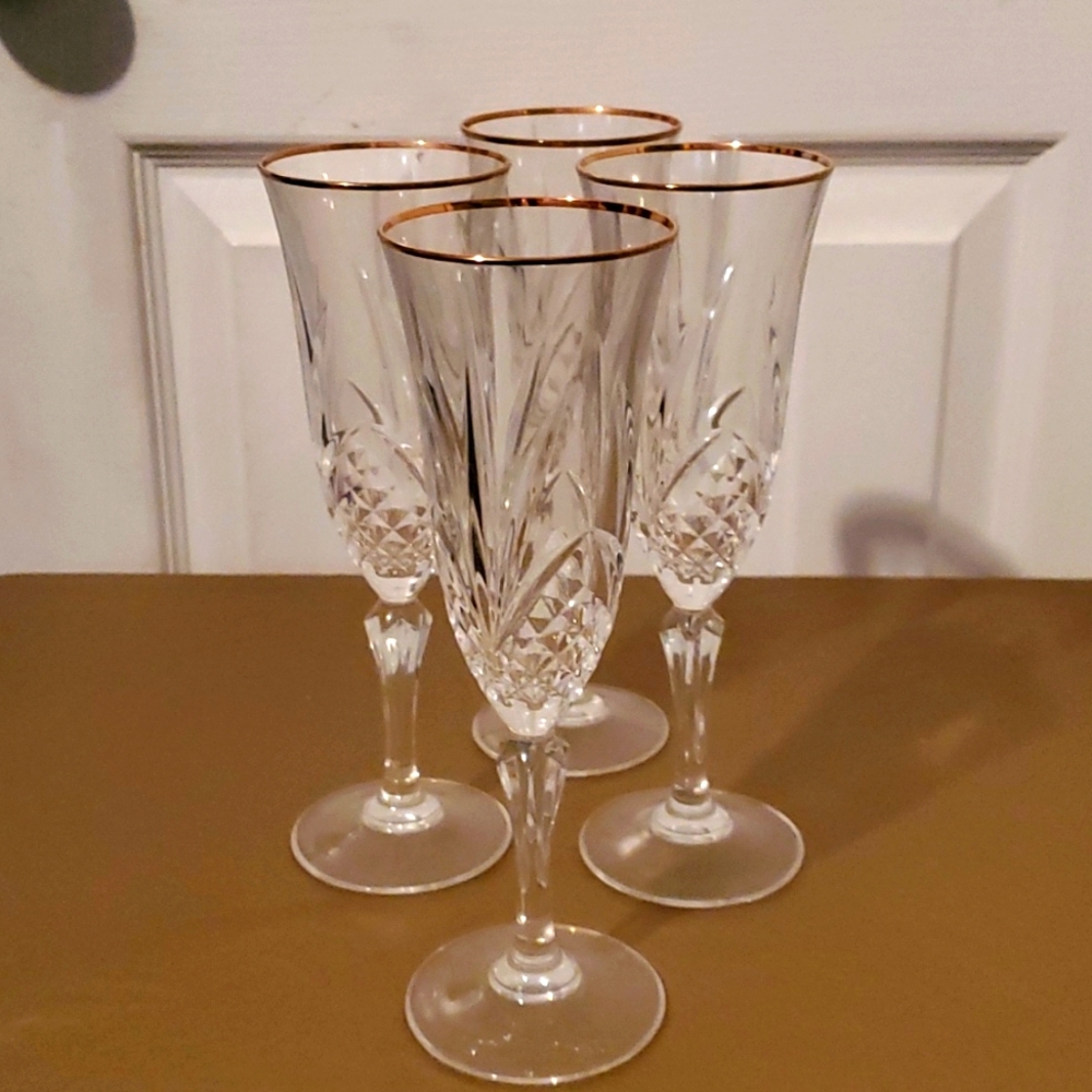 Set of crystal etched gold rim champagne flutes
